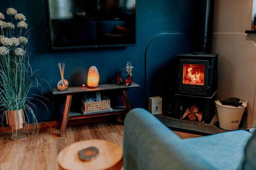 Tŷ Cosy lounge with the log-burning stove lit